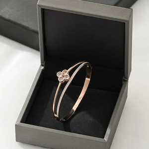 Rose gold lucky four-leaf clover stainless steel bracelet in a luxury jewelry box