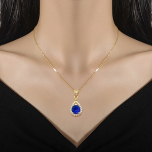 Luxurious gold titanium necklace with blue water drop pendant and sparkling crystals