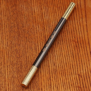 Detail of brass rollerball pen featuring the Golden Cudgel staff design and engraving