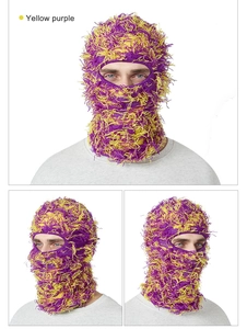 Detail of yellow and purple fuzzy knit balaclava showing long plush texture and distressed style