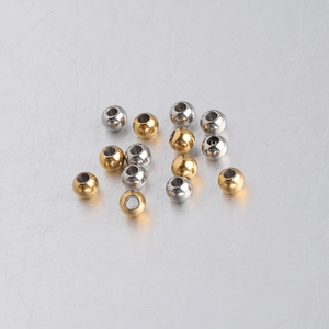 Macro shot of 5mm gold and silver stainless steel spacer beads for DIY jewelry making