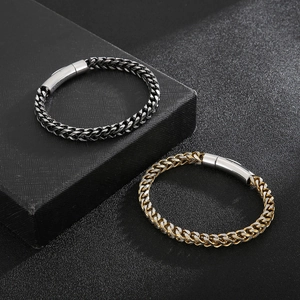 Close-up of black and gold dragon bone chains with magnetic clasps on gift box