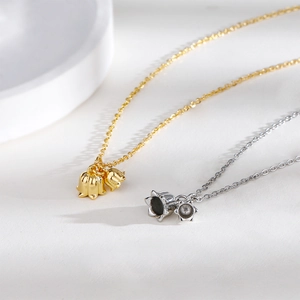 Macro detail of S925 lily of the valley pendants in gold and silver finishes