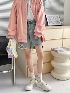 Detail of colorful cartoon cotton crew socks with rainbow prints on a female model