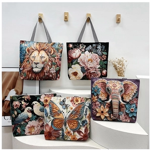 Detailed close-up of 3D ethnic floral and butterfly embroidery on a canvas tote bag