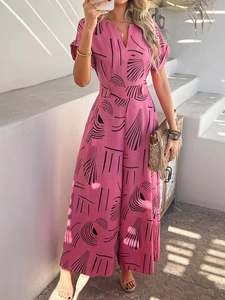 Detailed view of pink jumpsuit featuring black abstract print and button-down waist detail
