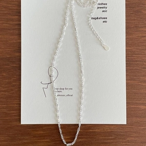 Close-up of S925 sterling silver chain necklace with adjustable tail tag and engraving