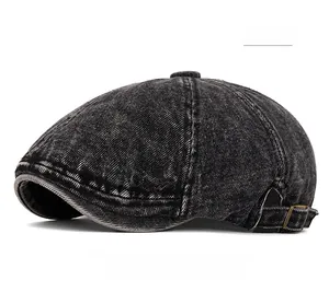 Close-up of black washed denim beret featuring metallic side buckle and vintage texture