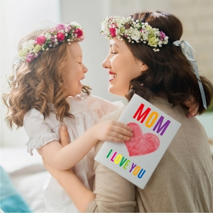 Detail of floral crown set for mother and daughter with pink flowers and blue ribbons
