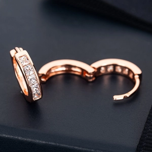 Detail of rose gold hoop earrings with square CZ zircons showing the hinge opening mechanism
