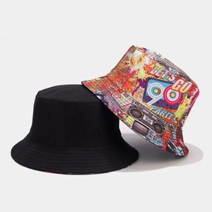 Detail of reversible bucket hat showing solid black side and retro 90s graffiti print