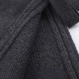 Fashionable dark grey wool blend knit vest top featuring side slits and refined texture