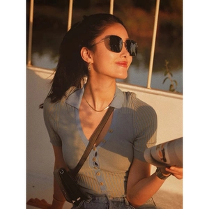 Model wearing a minimalist PVD plated stainless steel snake chain necklace in warm sunset light