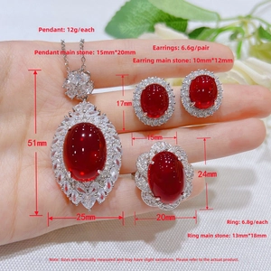 Macro detail of red gemstone jewelry set with necklace pendant and sparkling stud earrings
