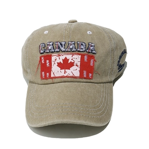 Detail of embroidered Canada logo and maple leaf flag on khaki vintage baseball cap