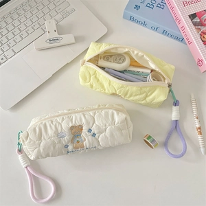 Detail of quilted cotton pencil case with bear embroidery and woven zipper lanyard
