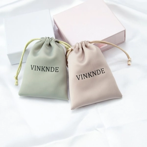 Luxurious satin drawstring jewelry bags and matching gift boxes in soft pastel tones