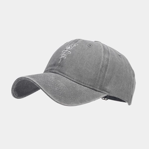Detail view of washed grey cotton baseball cap with faith print and dandelion design