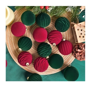 Detail of burgundy and dark green velvet Christmas ornaments on a rustic straw mat