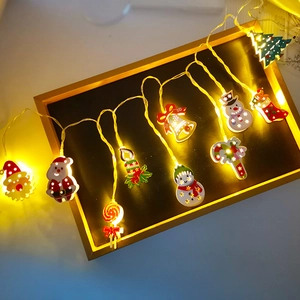 Festive Christmas LED string lights with Santa and snowman shapes in warm white glow