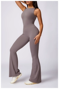 Detail view of dark grey flare yoga jumpsuit showing slim fit waist and flared leg style