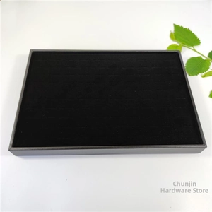 Close-up of black velvet 100-slot jewelry display tray for rings and small earrings