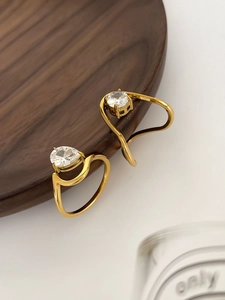 Detailed macro view of 18K gold plated ring with pear and round zircon stone settings