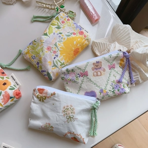 Detailed close-up of floral cotton coin purses with zipper pulls and sweet pattern prints