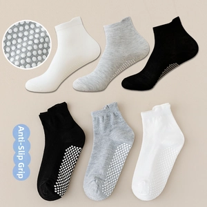 Detail of baby floor socks featuring non-slip silicone dots on cotton blend fabric