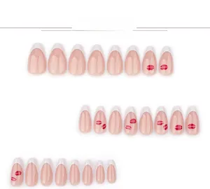 Flat lay of 24 white French almond press-on nails featuring stylish red lip print designs