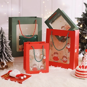 Close-up of red and green hollowed Christmas gift bags with festive handles