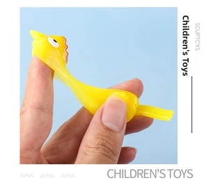 Elastic yellow chicken toy being stretched by hand against a blue background
