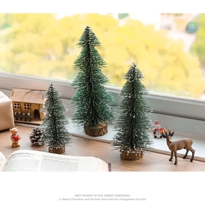 Three sizes of flocked mini Christmas trees with wooden bases for festive tabletop decor