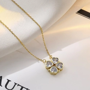 Golden heart-shaped clover necklace with zircon crystals on a fine link chain