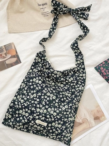 Floral print canvas tote bag with adjustable shoulder ribbon straps and blue floral pattern