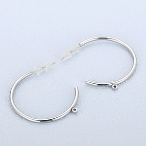 Macro detail of silver stainless steel C-shaped earring hooks for DIY jewelry making