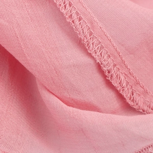 Close-up of pink midi dress showing breathable fabric texture and tight overlock stitching