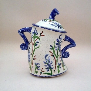 Artistic hand-painted ceramic storage jar with blue floral motifs and unique bent handles