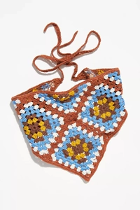 Detailed close-up of handmade crochet bandana featuring floral patterns and knit textures