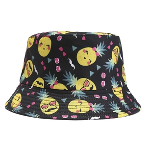 Reversible cotton bucket hat with colorful pineapple patterns on a black background