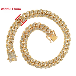 Close-up of 13mm wide gold iced out Cuban link chain with detailed fold-over clasp