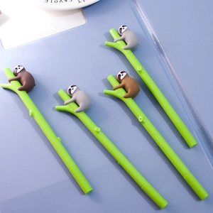 Close-up of four cute sloth pens with green branch-shaped barrels and silicone charms