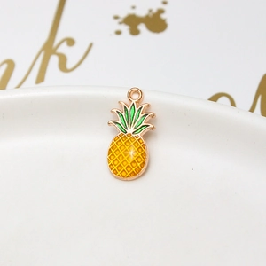 Macro detail of a yellow enamel pineapple charm for DIY jewelry making accessories