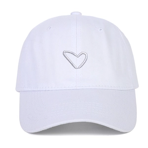 Close-up of heart embroidery and cotton twill texture on a white baseball cap