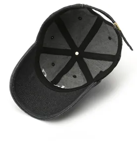 Detail view of the black denim baseball cap interior structure with adjustable strap