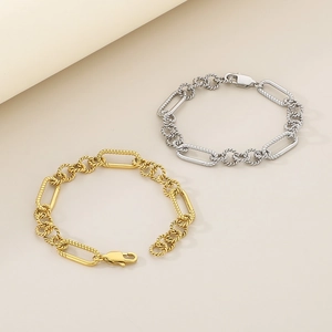 Detail of twisted geometric chain link bracelet in gold and silver stainless steel