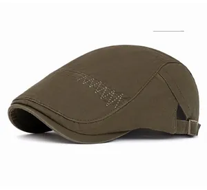 Detail of army green newsboy cap featuring decorative stitching and adjustable metal buckle