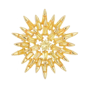 Exquisite golden sunburst brooch featuring sparkling yellow micro-pave crystals on white background