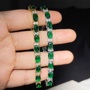 Gold and silver tennis bracelets featuring emerald-cut green zircons and white stones