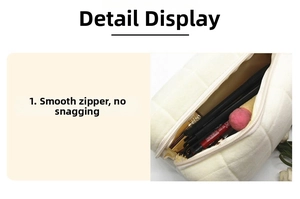 Detail showing smooth white quilted pouch zipper and spacious interior storage